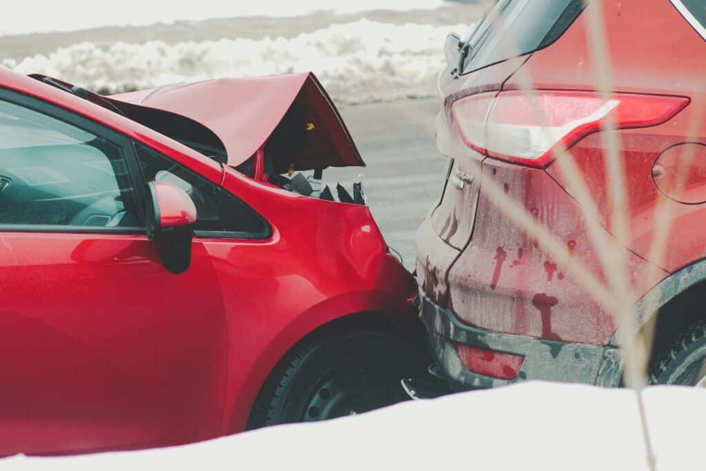 Current image: a red car parked next to another red car